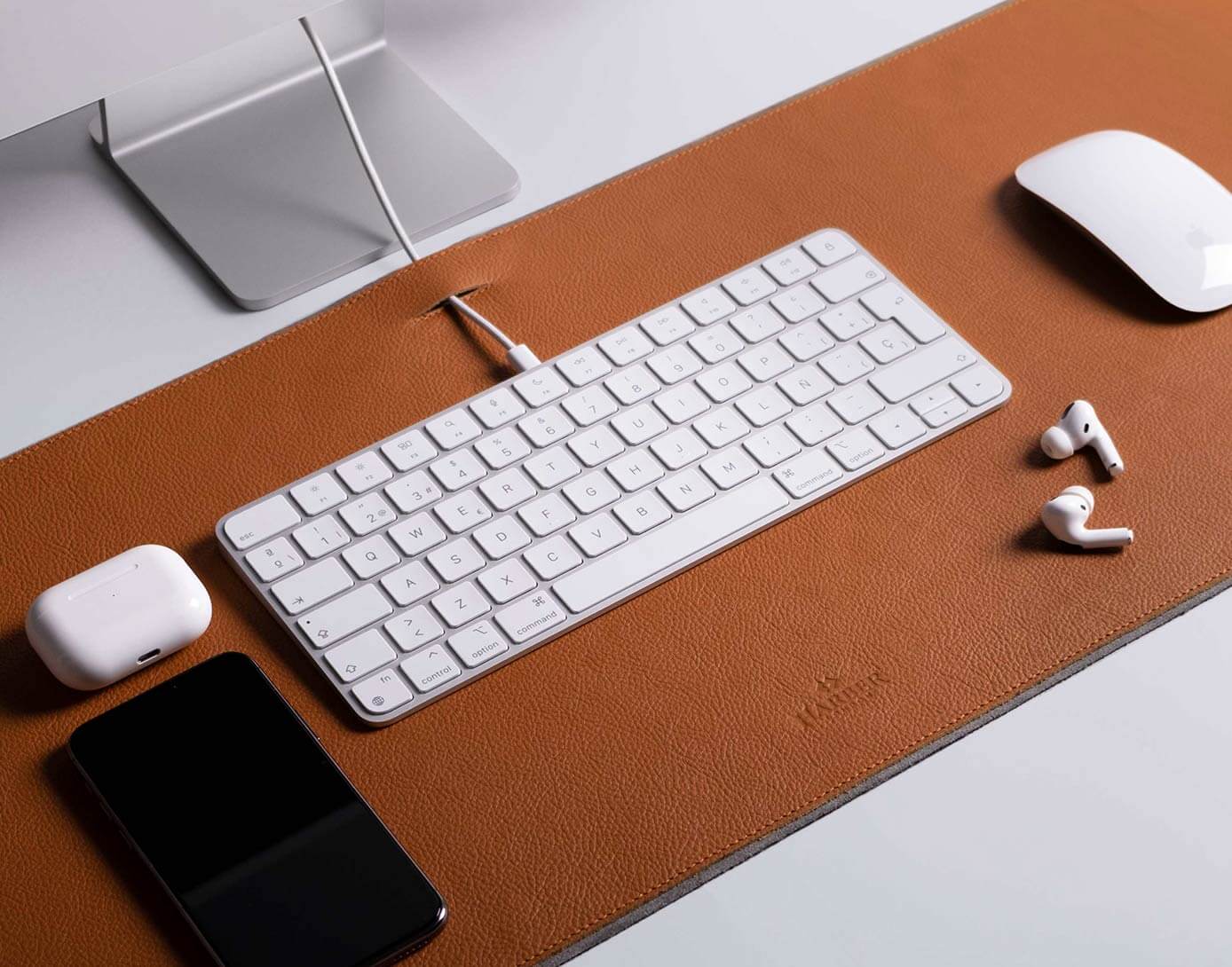 Minimalist desk setup with a leather desk pad