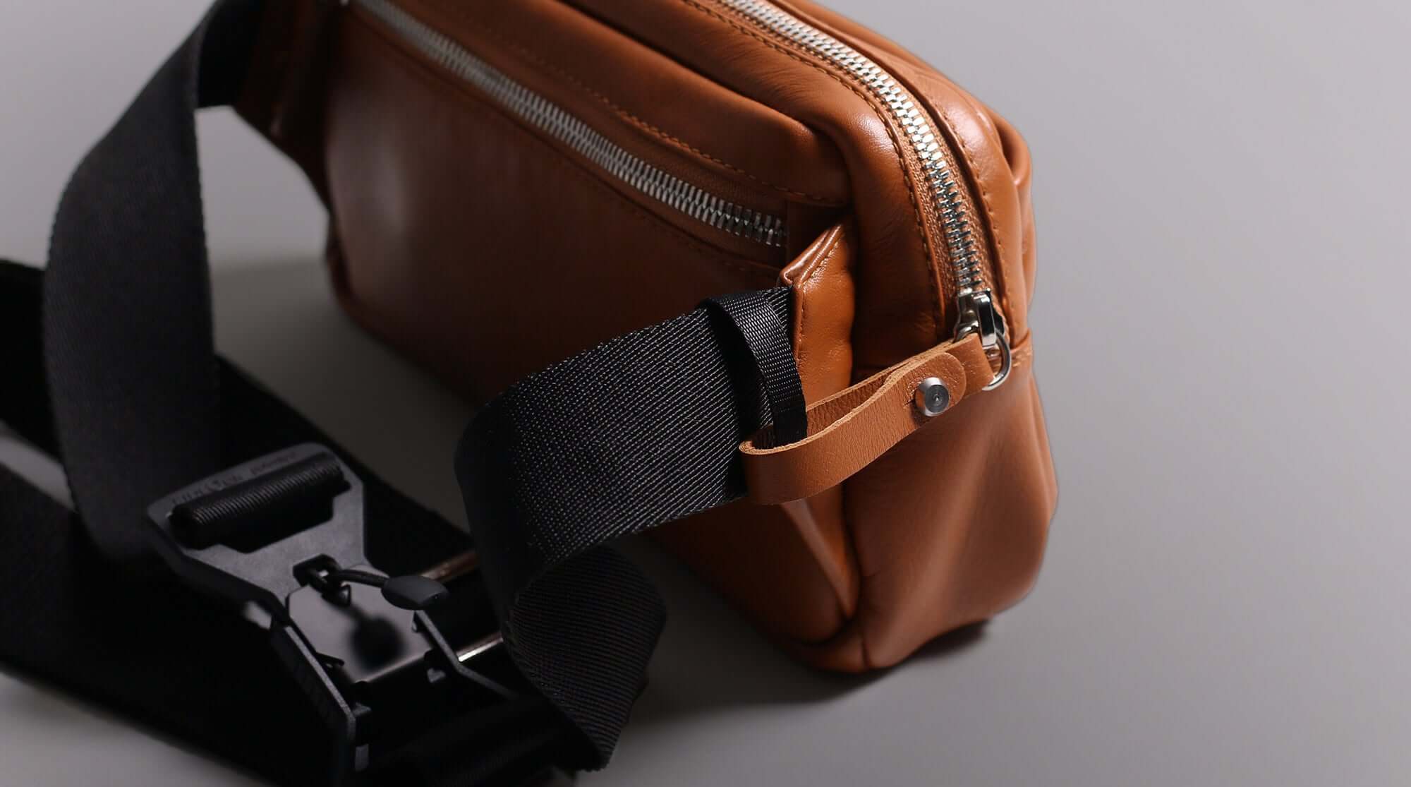 Handcrafted leather sling bag with security pull tab